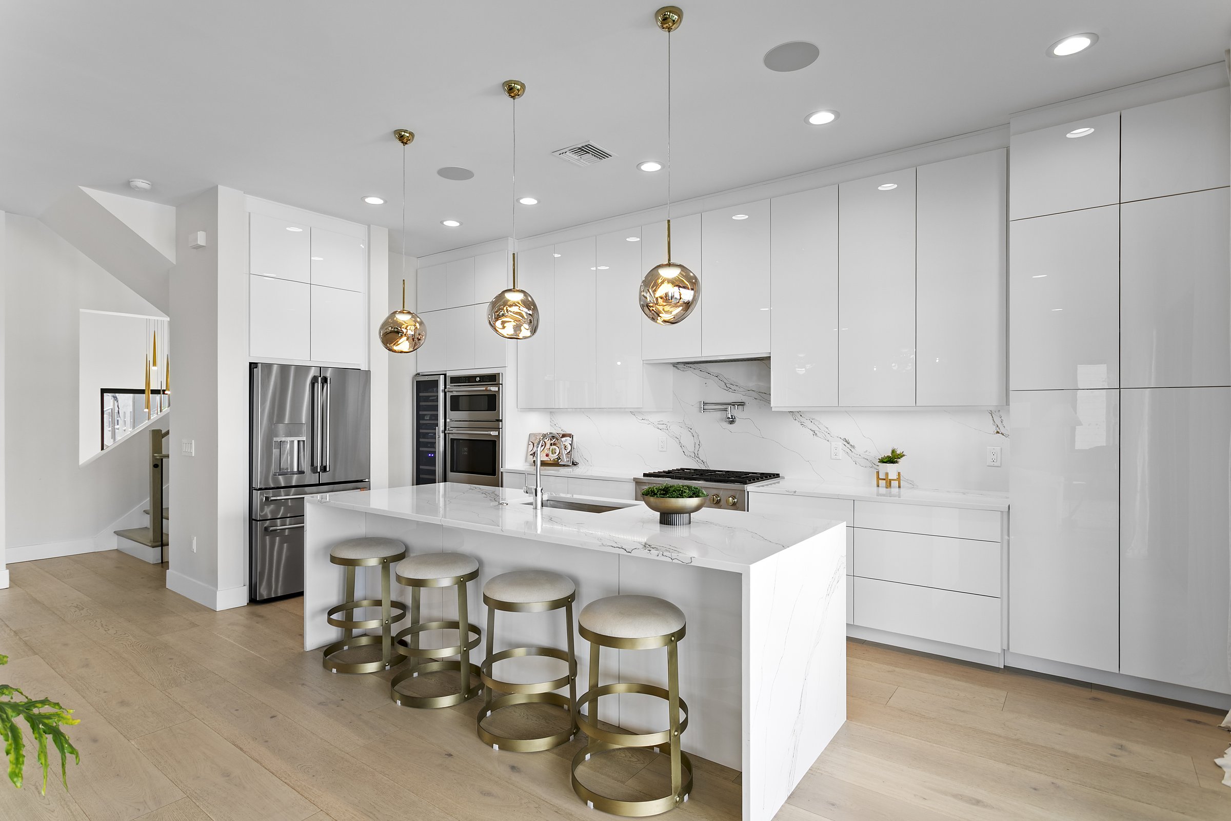 Kitchen with quartz waterfall island and GE Café appliances