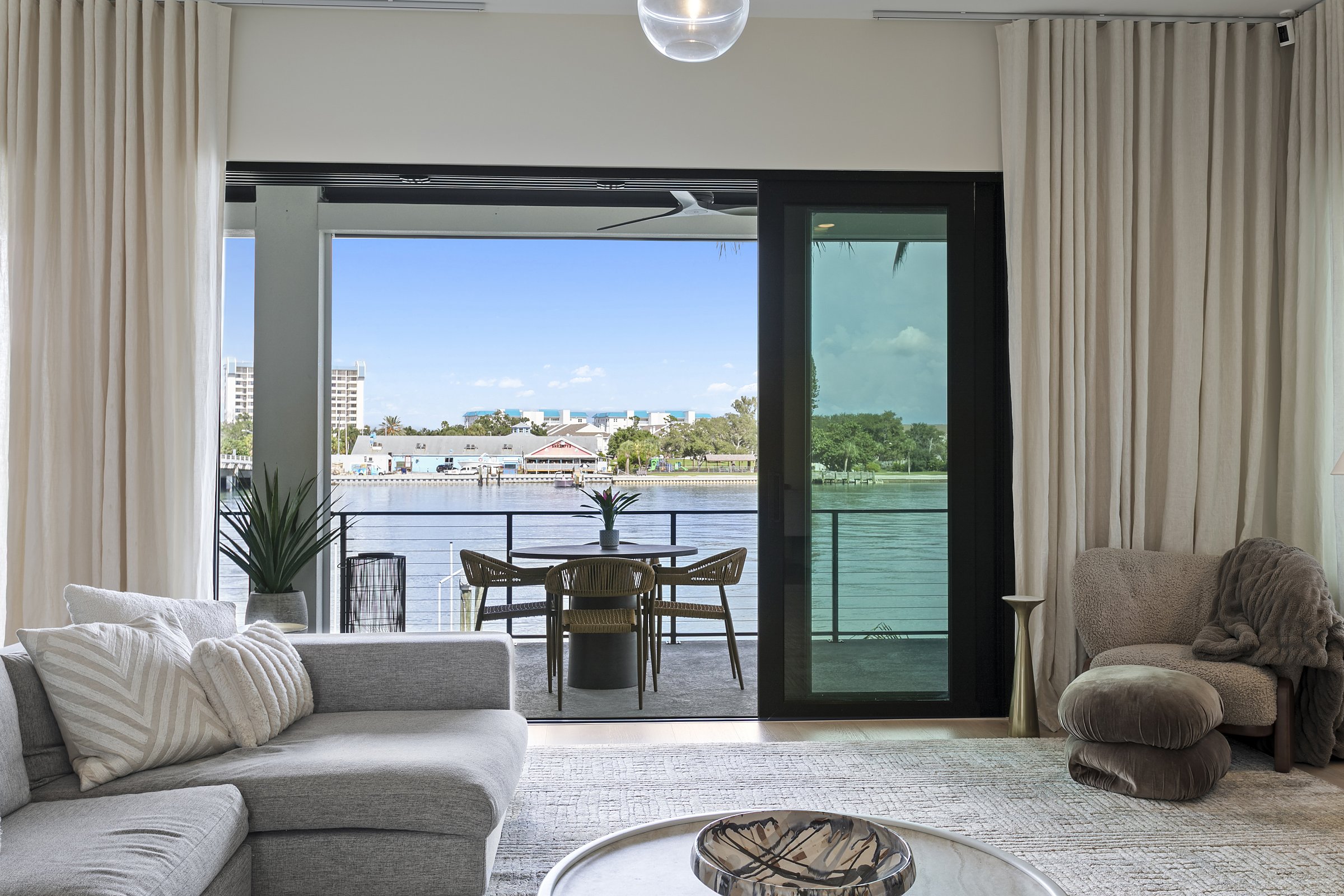 Living room open to the balcony and water