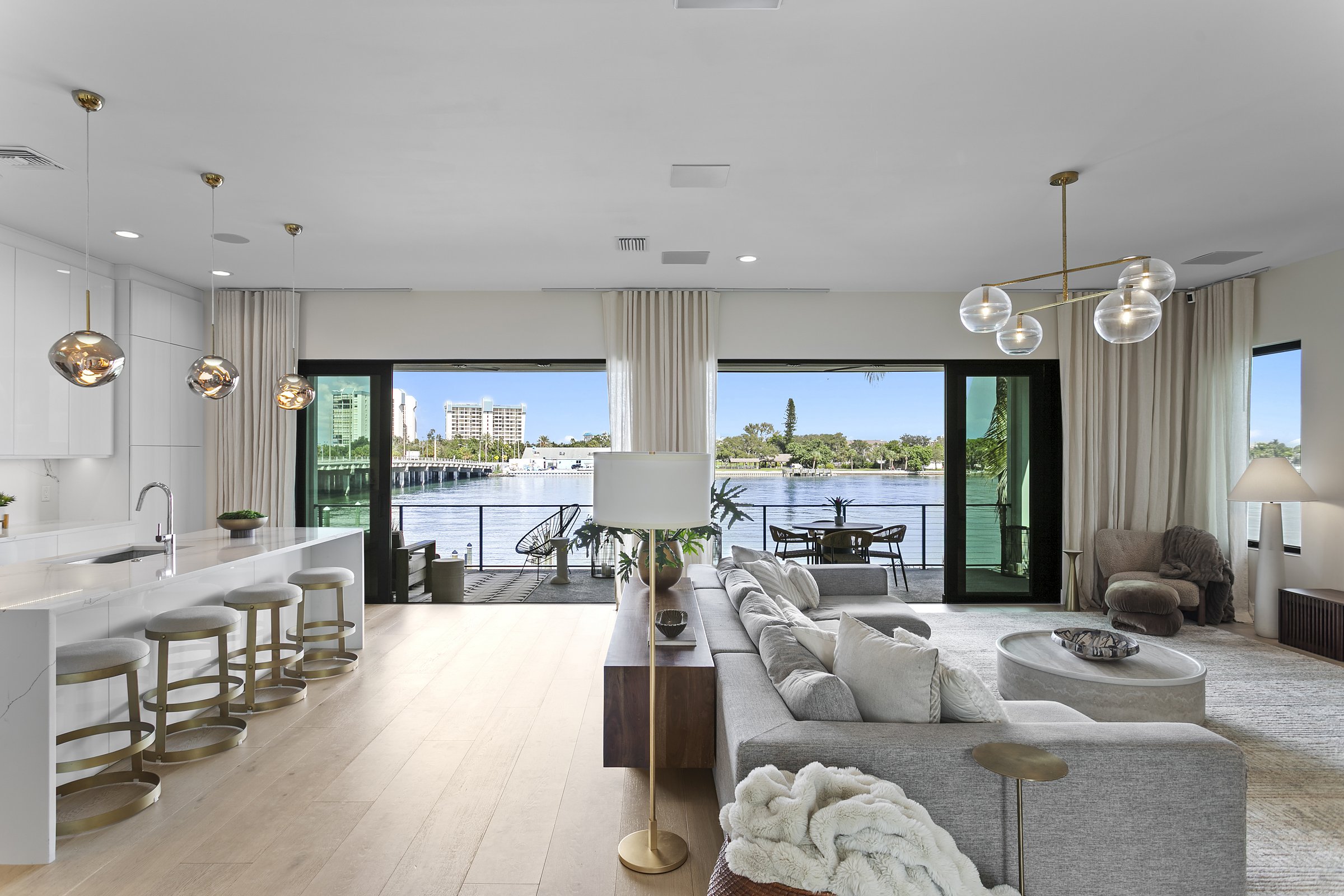 Open living room and kitchen with water views