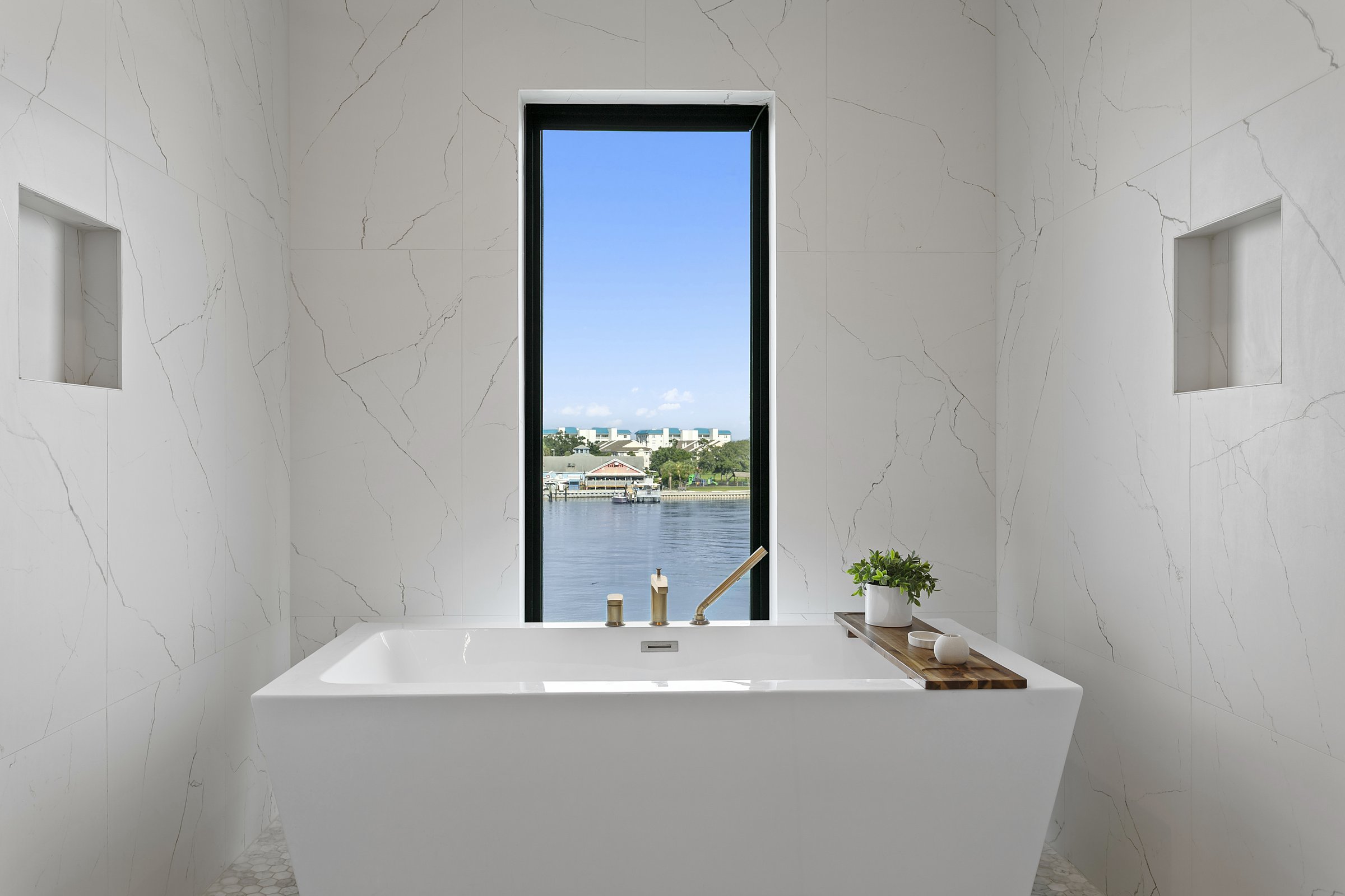 Freestanding soaking tub with a water view
